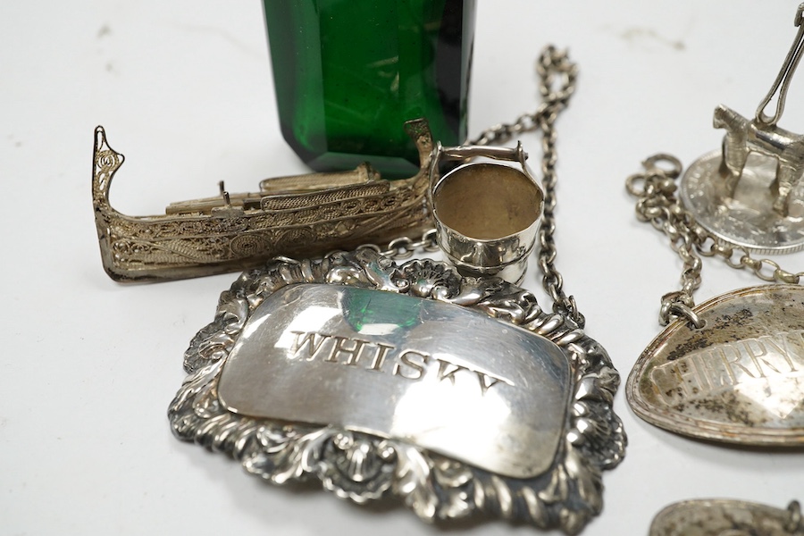 Sundry small silver including a vesta case, two wine labels, mounted glass scent bottle, wishbone sugar nips, sovereign case, etc. and a plated wine label. Condition - poor to fair to good